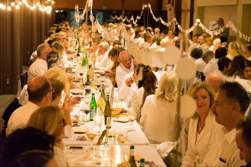 Guests enjoying the festive Long Table Dinner ”en blanc” experience